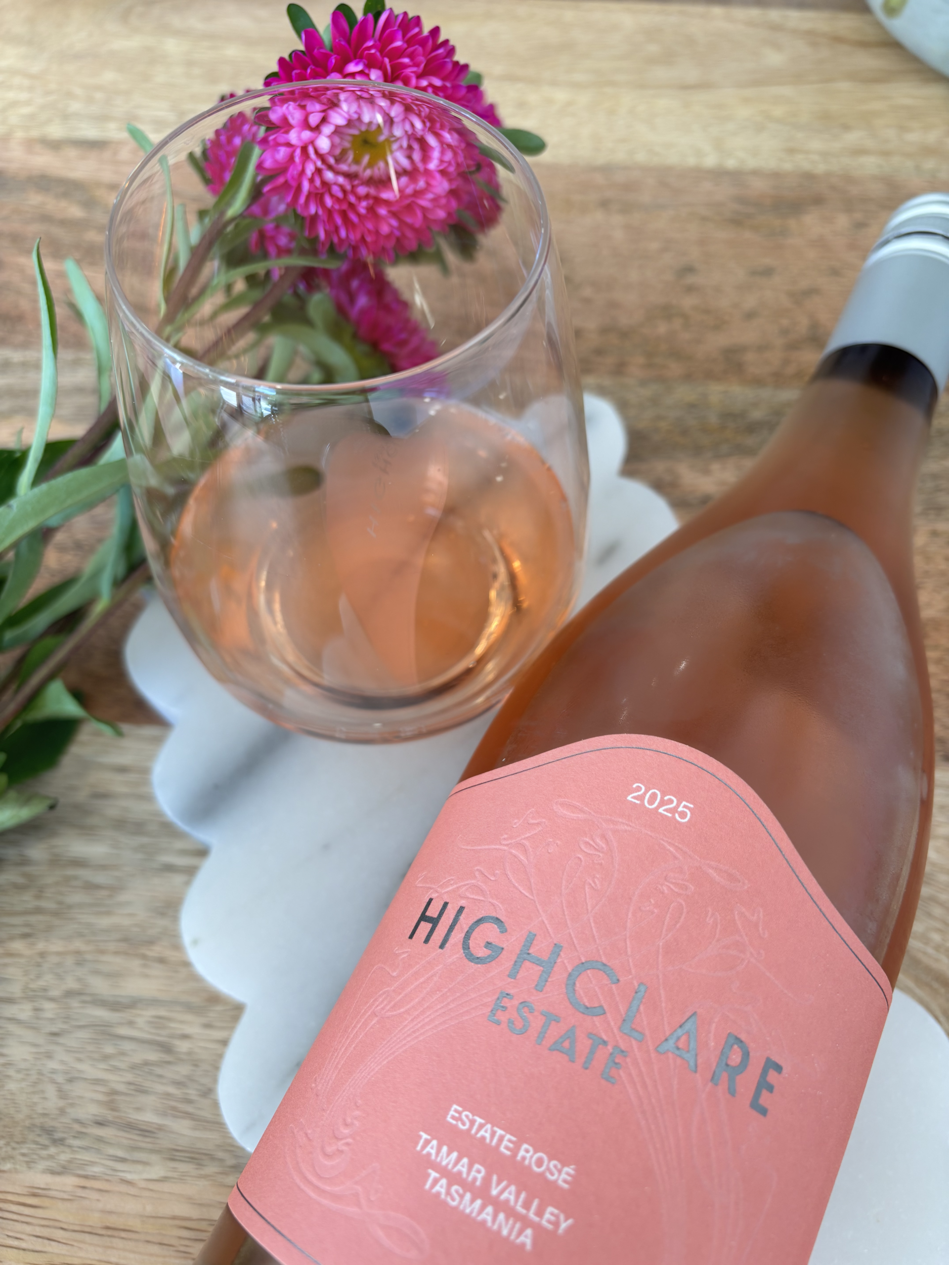 Highclare Estate rosé wine with flowers on table.