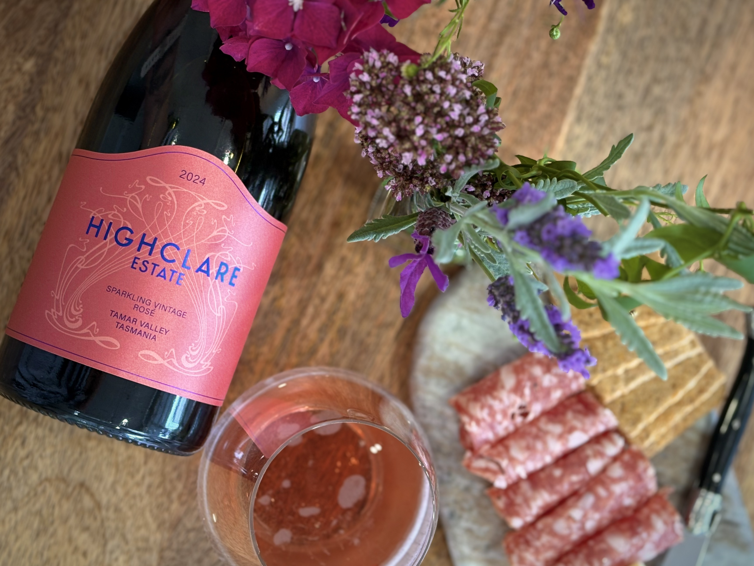 HighClare Estate Sparkling Rosé wine with salami and crackers.