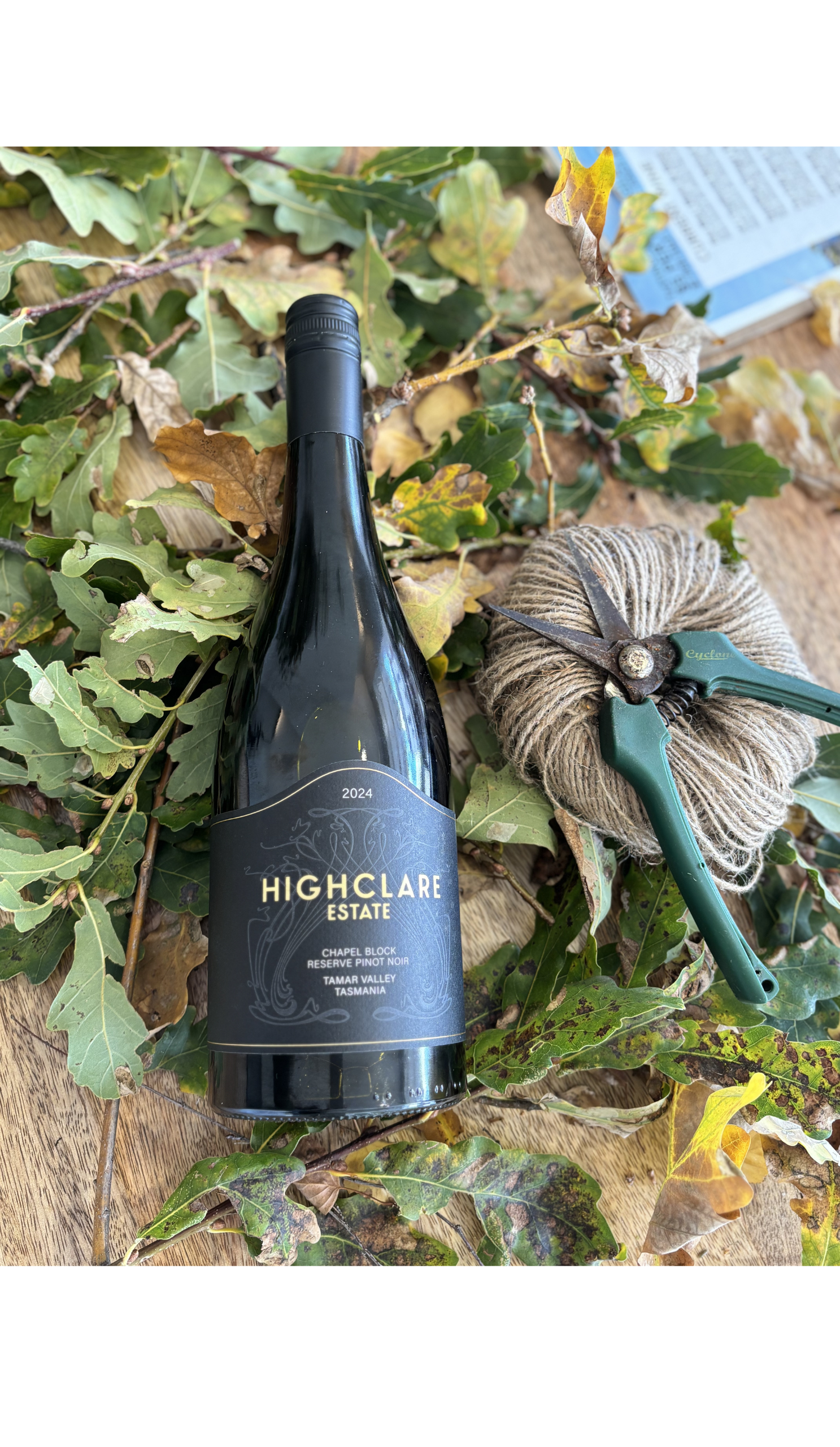 Pinot Noir bottle with leaves and pruning shears