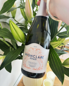 Bottle of Highclare Estate sparkling wine among lilies