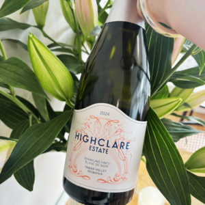 Bottle of Highclare Estate sparkling wine among lilies