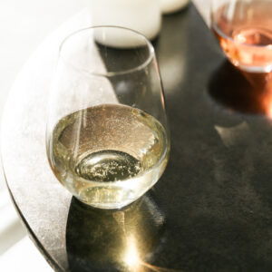Sparkling white wine glass on sunlit table